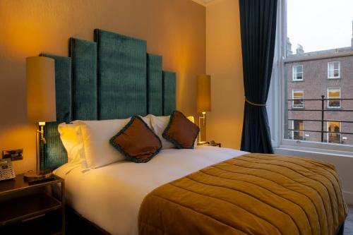 a bedroom with a large bed with a large window at Number 31 in Dublin