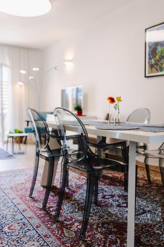 a dining room with a table and chairs on a rug at San Francis in Hvar