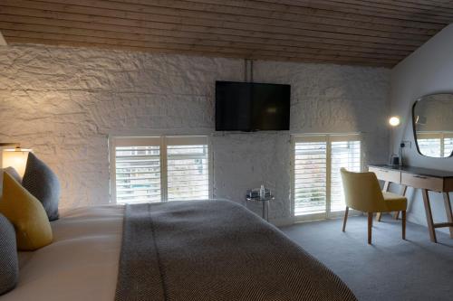 a bedroom with a bed and a desk with a television at Number 31 in Dublin