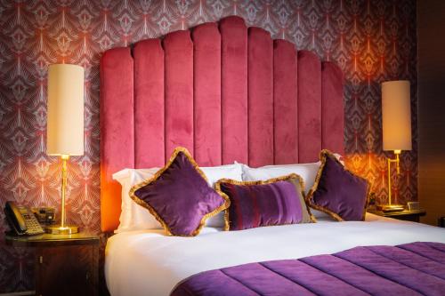 a bedroom with a large bed with purple pillows at Number 31 in Dublin