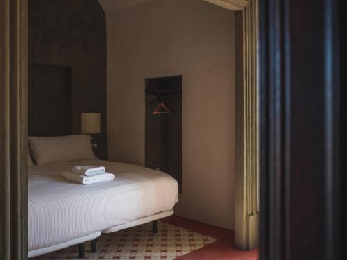 a bedroom with a bed with two towels on it at Can Campolier in Porqueres