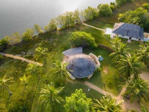 an aerial view of a house on a hill with palm trees at Elements Beach & Nature Resort in Kalpitiya