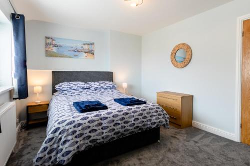 a bedroom with a bed and a mirror on the wall at Island View in Amble