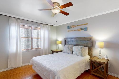 a bedroom with a bed and a ceiling fan at Lei Lani Village 110 in Orange Beach