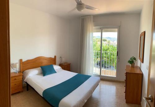 um quarto com uma cama e uma grande janela em Kione Villamar em Alcossebre