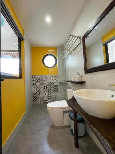 a bathroom with a sink and a toilet at La Y Riverview in Hue