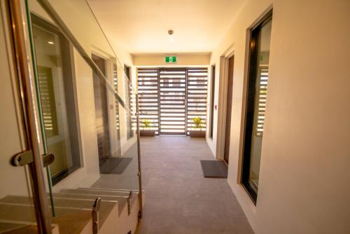 a hallway of a building with stairs and doors at El Palm in Nadi