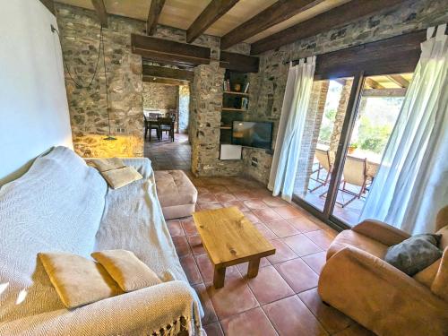 a living room with a couch and a coffee table at Can Nofre - Masia familiar en zona tranquila in Amer