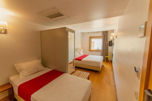 a hotel room with two beds in a room at Cascais Hotel in Cascais