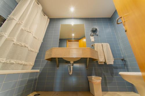 a bathroom with a sink and a mirror at Cascais Hotel in Cascais