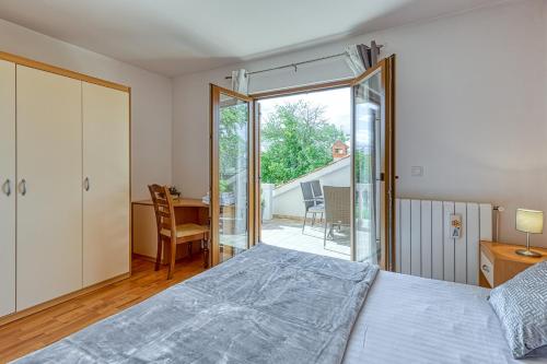 a bedroom with a bed and a sliding glass door at Apartment Maružini in Kanfanar