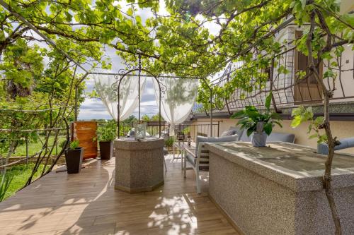 a patio with a table and chairs and trees at Apartment Maružini in Kanfanar
