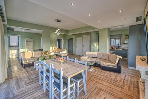 a dining room and living room with a table and chairs at Anemomili Villas in Drapaniás