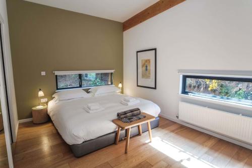 a bedroom with a large white bed and two windows at Yorkshire Dales Lodge 16 by Together Travel - 3-Bed Premium Ensuite in Richmond