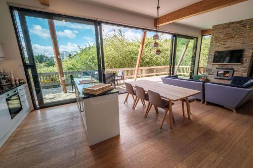 a kitchen and living room with a table and a couch at Yorkshire Dales Lodge 16 by Together Travel - 3-Bed Premium Ensuite in Richmond