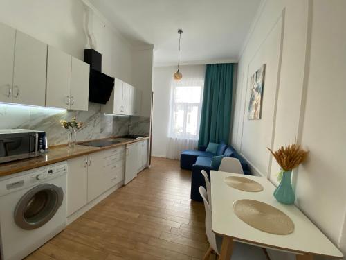 a kitchen with a table and a dining room at Квартира на Огієнка 15 in Lviv