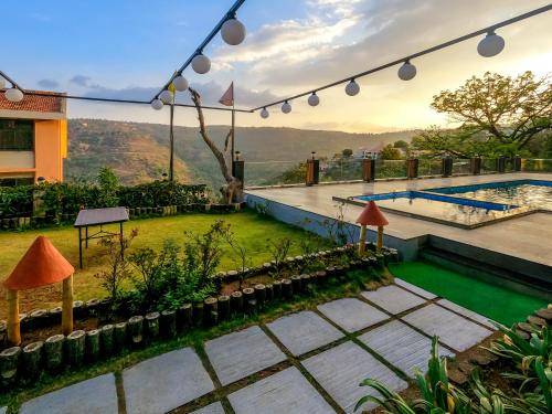 a villa with a pool and a view at Sterling Panchgani in Panchgani