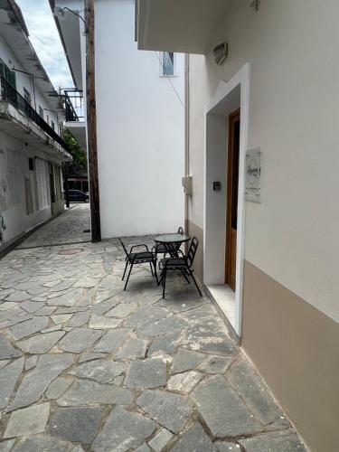 a patio with two chairs and a table next to a building at Lagom House in Panayia