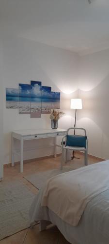 a bedroom with a bed and a desk and a chair at TENUTA FERRARI in Cortile