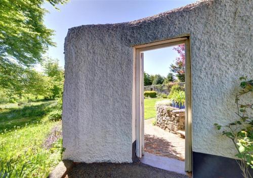 a doorway to a small building with a door at The Dairy in Llandegfan