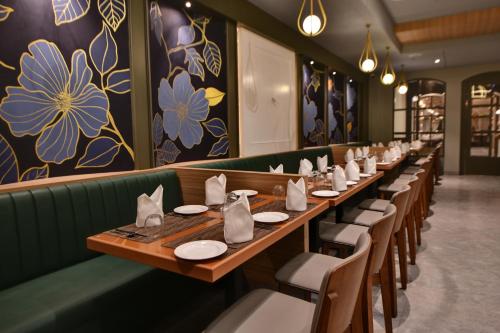 a row of tables and chairs in a restaurant at The Fern Shelter Resort Palghar in Manor