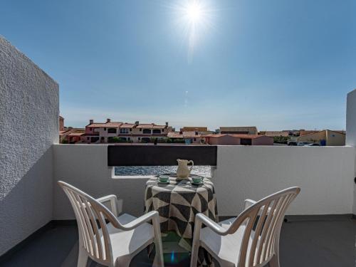 a table and chairs on a balcony with a view at Holiday Home Les Brigantins-1 by Interhome in Port Leucate