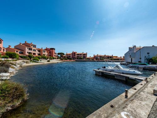 a boat docked at a dock in a river at Holiday Home Les Brigantins-1 by Interhome in Port Leucate