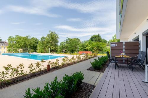 a backyard with a pool and a table and chairs at Pauzo Balaton in Balatonföldvár