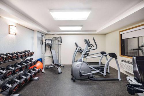 a gym with treadmills and ellipticals in a room at AmericInn by Wyndham Duluth South Proctor Black Woods Event Ctr in Duluth