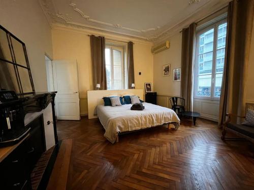 une chambre avec un lit sur lequel est allongé un chat dans l'établissement #Accords - Très Grande Suite type Chambre d’hôtel, à Brive-la-Gaillarde
