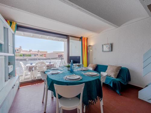 a living room with a table and a couch at Holiday Home Les Brigantins-3 by Interhome in Port Leucate