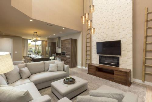 a living room with a couch and a tv at Magic Village Views Trademark Collection by Wyndham in Orlando