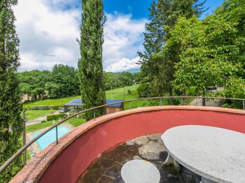 a circular walkway with a round table on a balcony at Holiday Home L'Orlo del Bosco by Interhome in Levane
