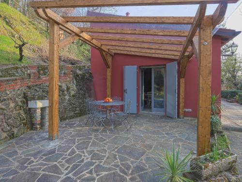 a patio with a wooden pergola and a table at Holiday Home L'Orlo del Bosco by Interhome in Levane