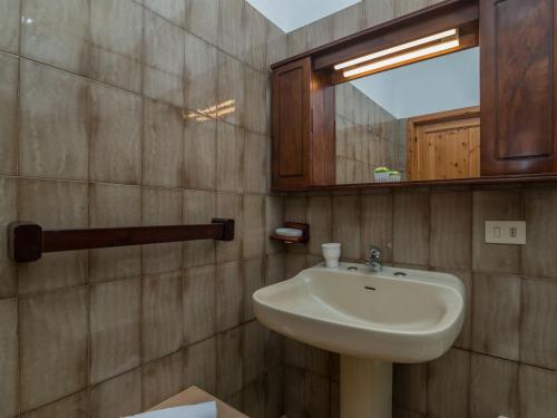 a bathroom with a sink and a mirror at Holiday Home Pietra by Interhome in Pittulongu