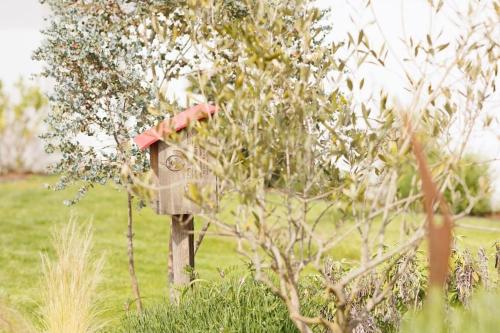 a bird house on a post in a field at Maison 3 chambres plus 1 studio indépendant in Sainte-Marie-de-Ré