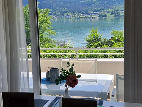 a vase with a flower on a table in front of a window at Apartment Vinzek by Interhome in Töschling