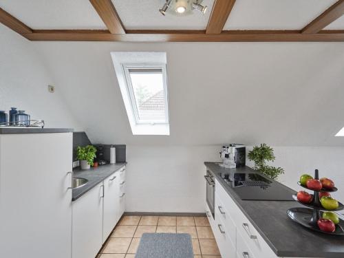 a kitchen with white cabinets and a window at Apartment Willingen by Interhome in Frankenau