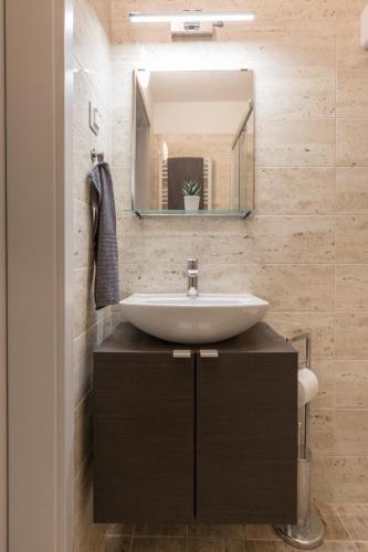 a bathroom with a sink and a mirror at Pauzo Balaton in Balatonföldvár