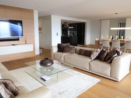 a living room with a couch and a glass table at Apartment L'Esplanade A3-8 by Interhome in Montreux