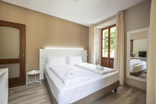 Postel nebo postele na pokoji v ubytování Hotel Il Portico by LVG Hotel Collection