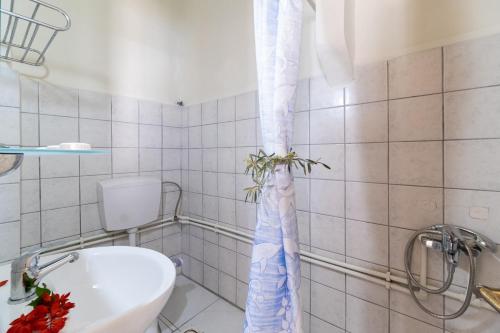 a bathroom with a toilet and a shower curtain at Nikiana Club - Studio 5 in Nikiana