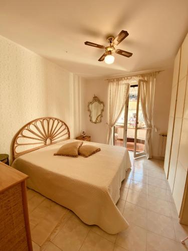a bedroom with a bed and a ceiling fan at Gogas Amalfi Coast in Cetara