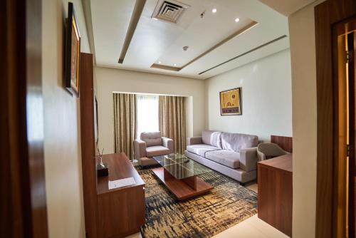 a living room with a couch and a table at The Lilygate Lagos in Lagos