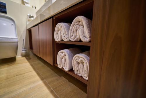 a towel rack with towels in a bathroom at The Lilygate Lagos in Lagos