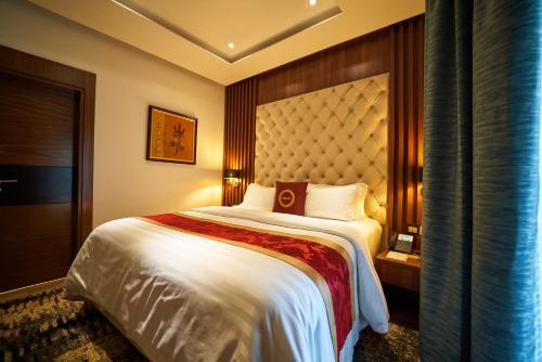 a bedroom with a large bed in a room at The Lilygate Lagos in Lagos