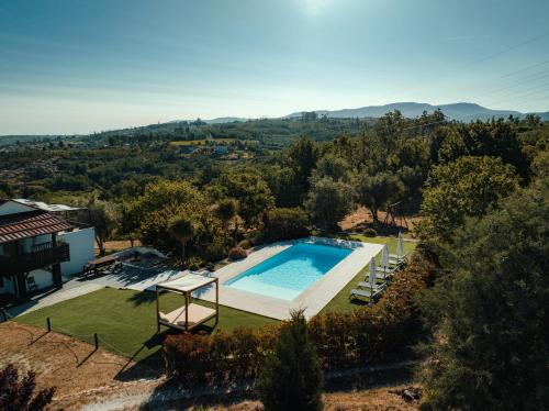 an overhead view of a swimming pool in a yard at Pura - Home in Nature in Oliveira do Hospital