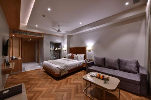 a hotel room with a bed and a couch at The Fern Shelter Resort Palghar in Manor