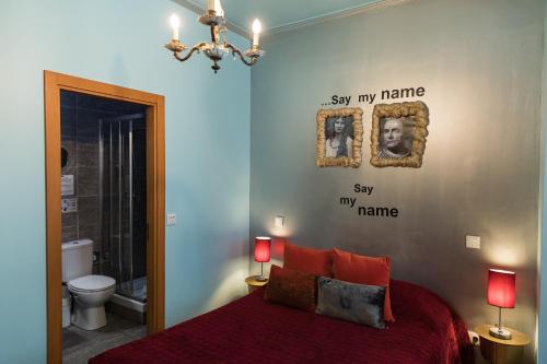 a bedroom with a bed with two lamps and a bathroom at Lisbon Art Stay Apartments Baixa in Lisbon