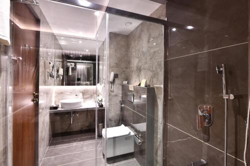 a bathroom with a shower and a sink at The Fern Shelter Resort Palghar in Manor